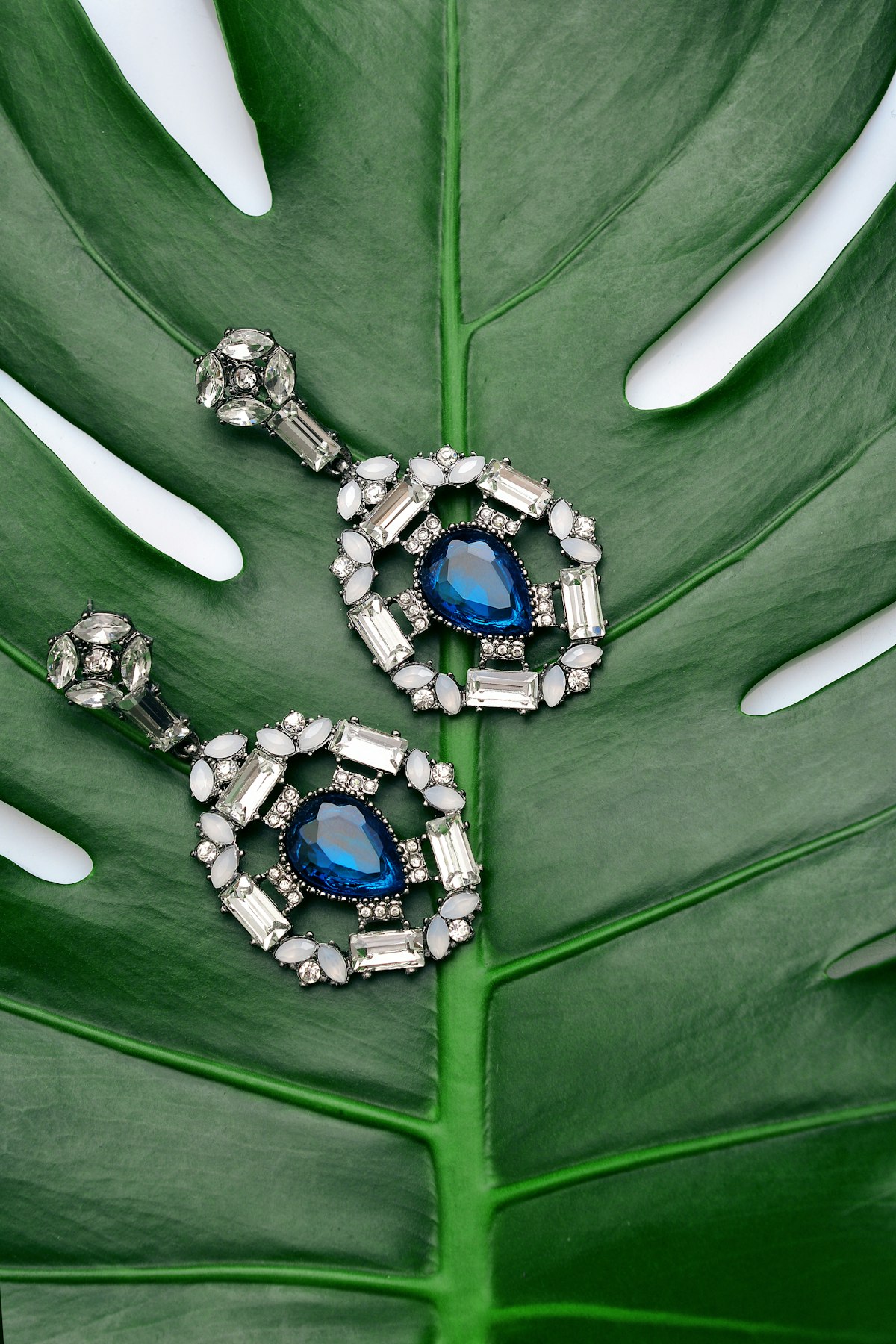 Antique jewelry pieces arranged for photography showing details and markings
