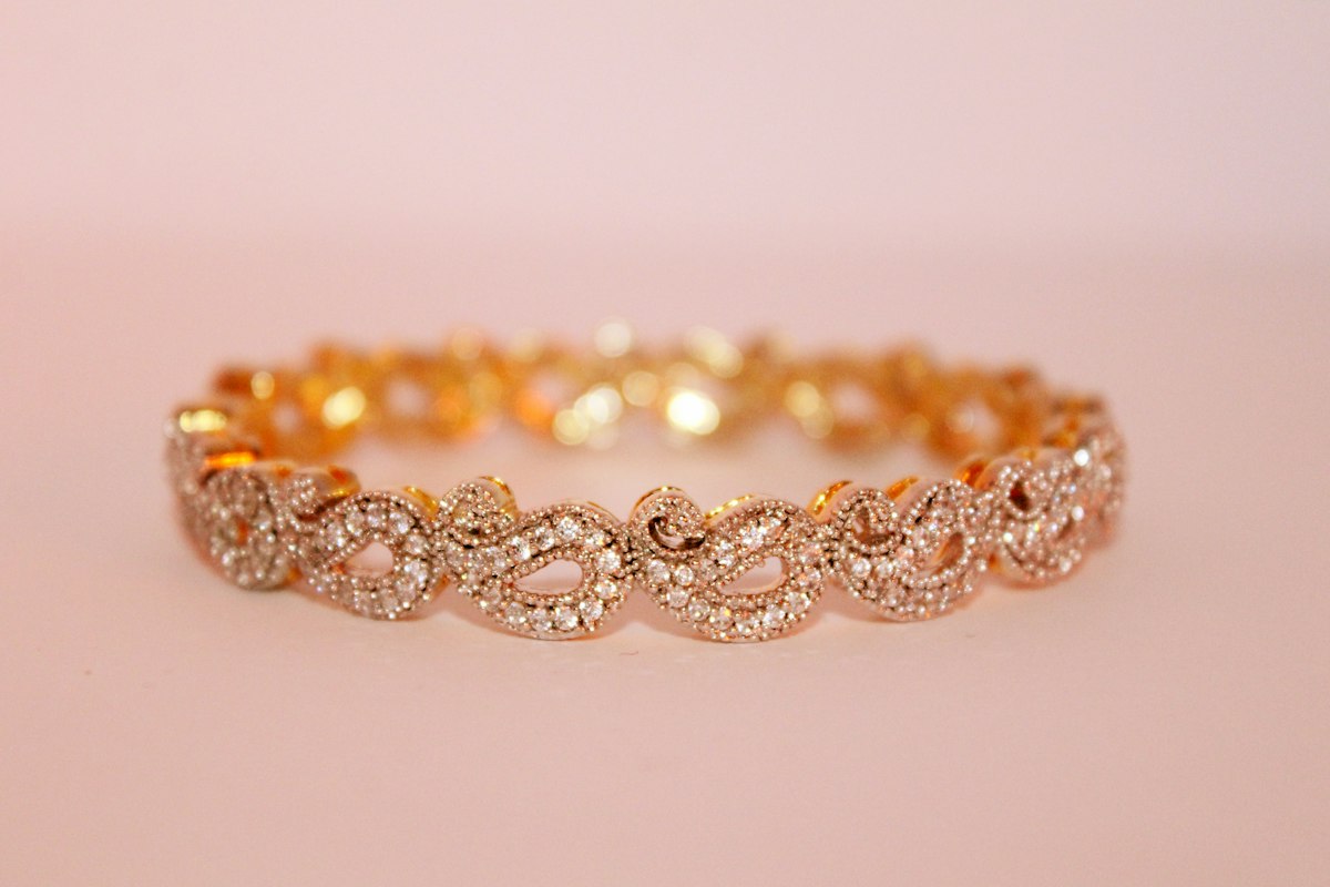 Close-up of antique gold hallmarks and stamps on vintage jewelry