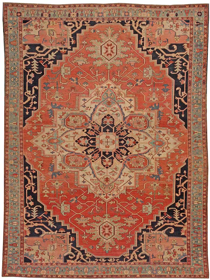 Antique Heriz Serapi Persian carpet showing a bold geometric medallion and hooked leaves
