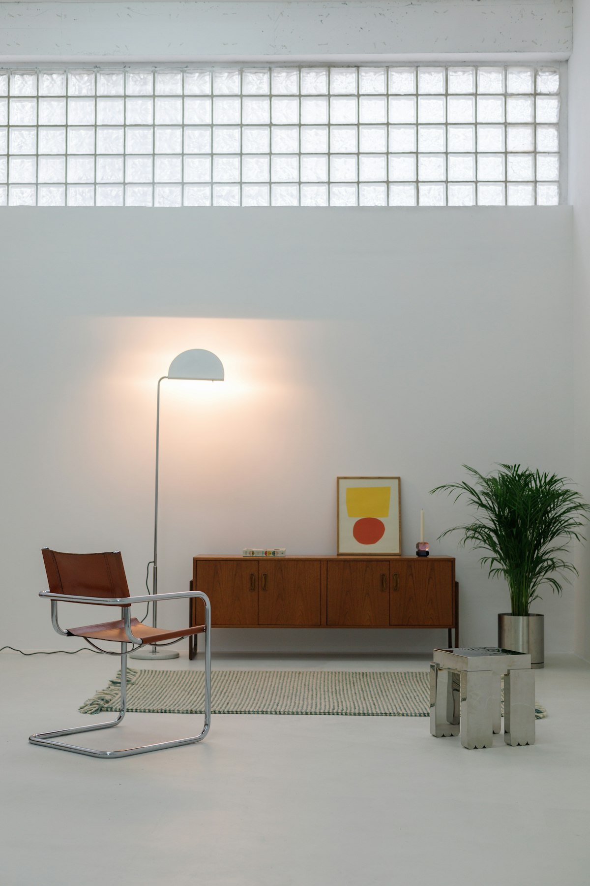 Mid-century modern living room with wooden chair, side table, and lamp